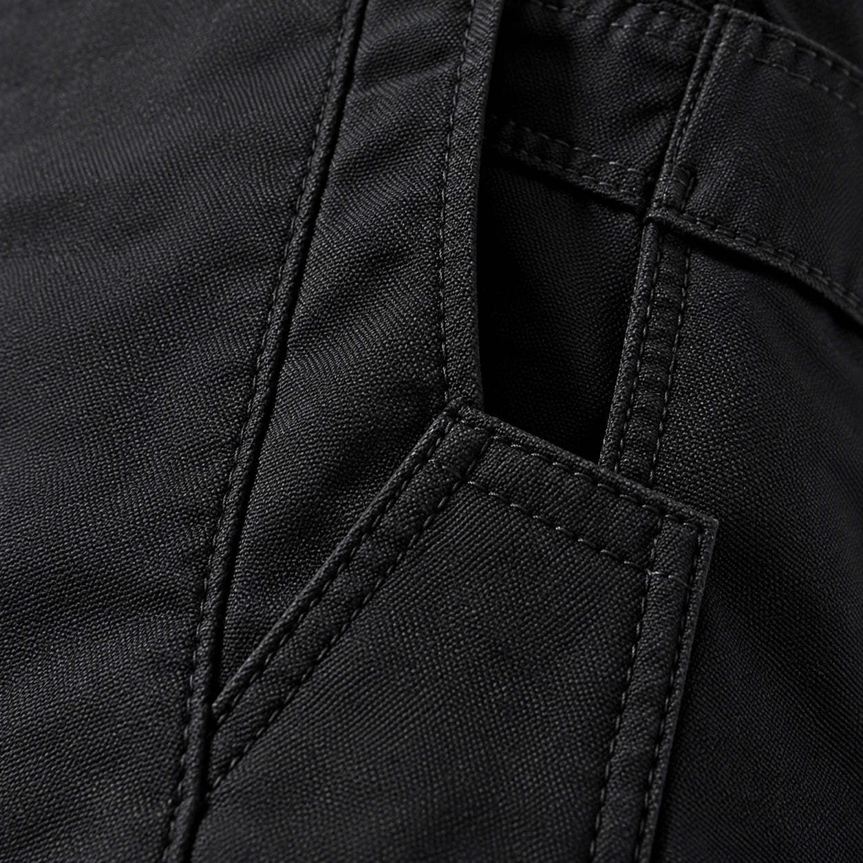 Close-up of the stitching on black work pants